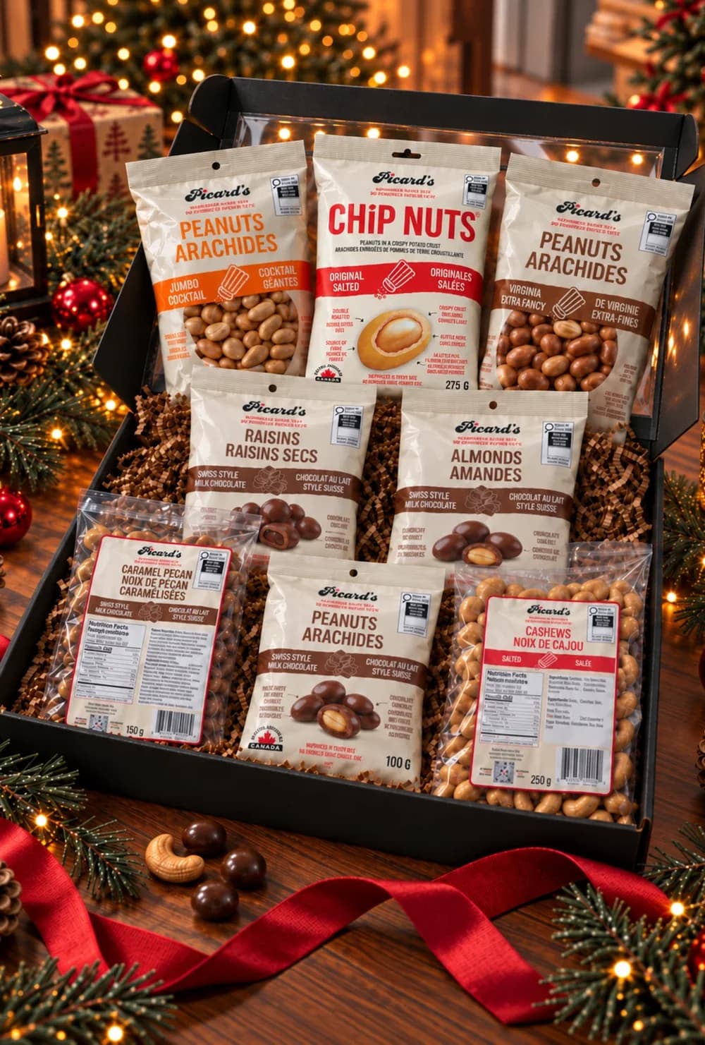 Picard's black holiday gift box filled with eight packs: peanuts, Chip Nuts, chocolate raisins, almonds and cashews, among pine and Christmas lights