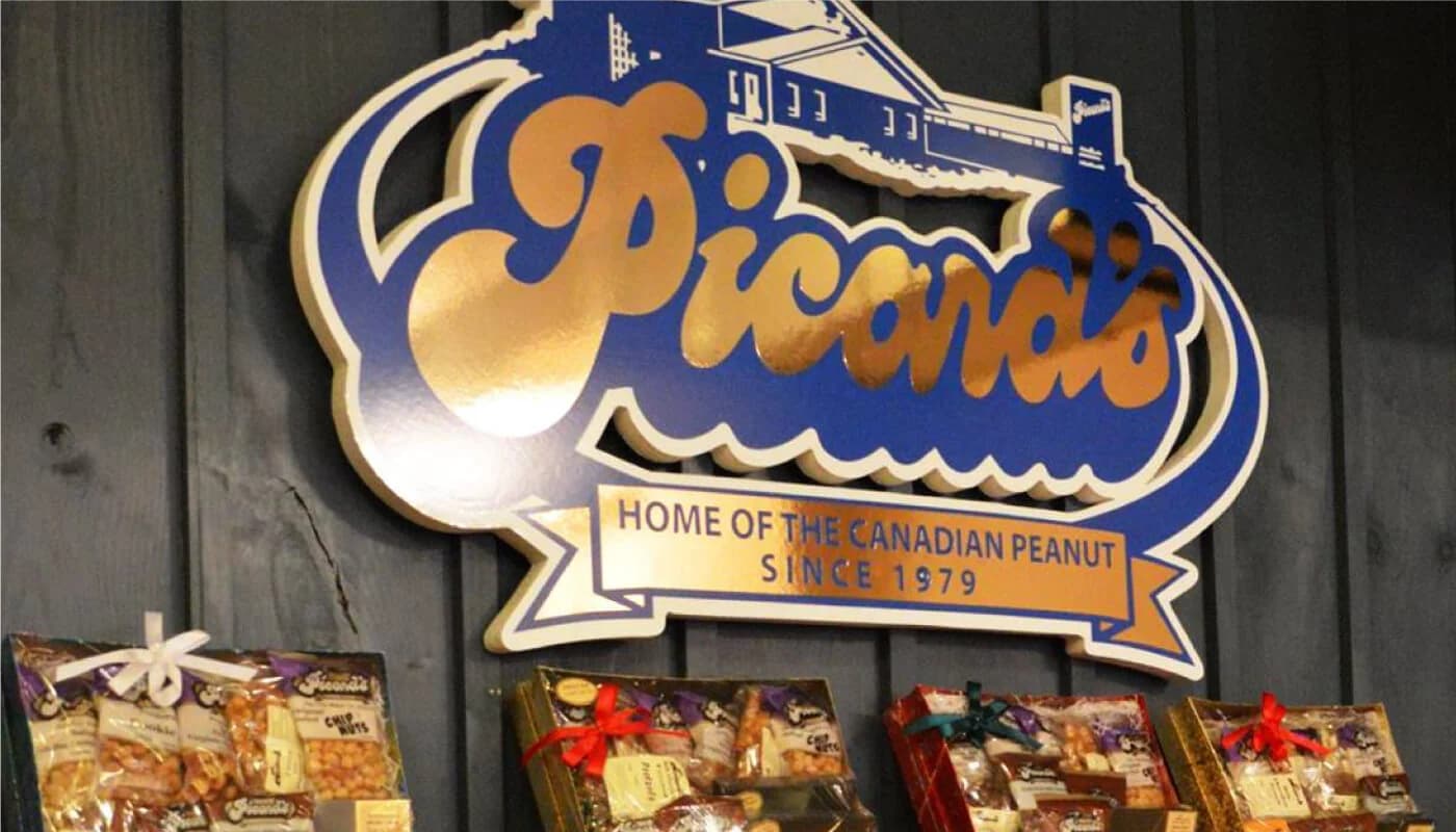 Inside a Picard's store: the 'Home of the Canadian Peanut since 1979' sign above shelves of gift boxes