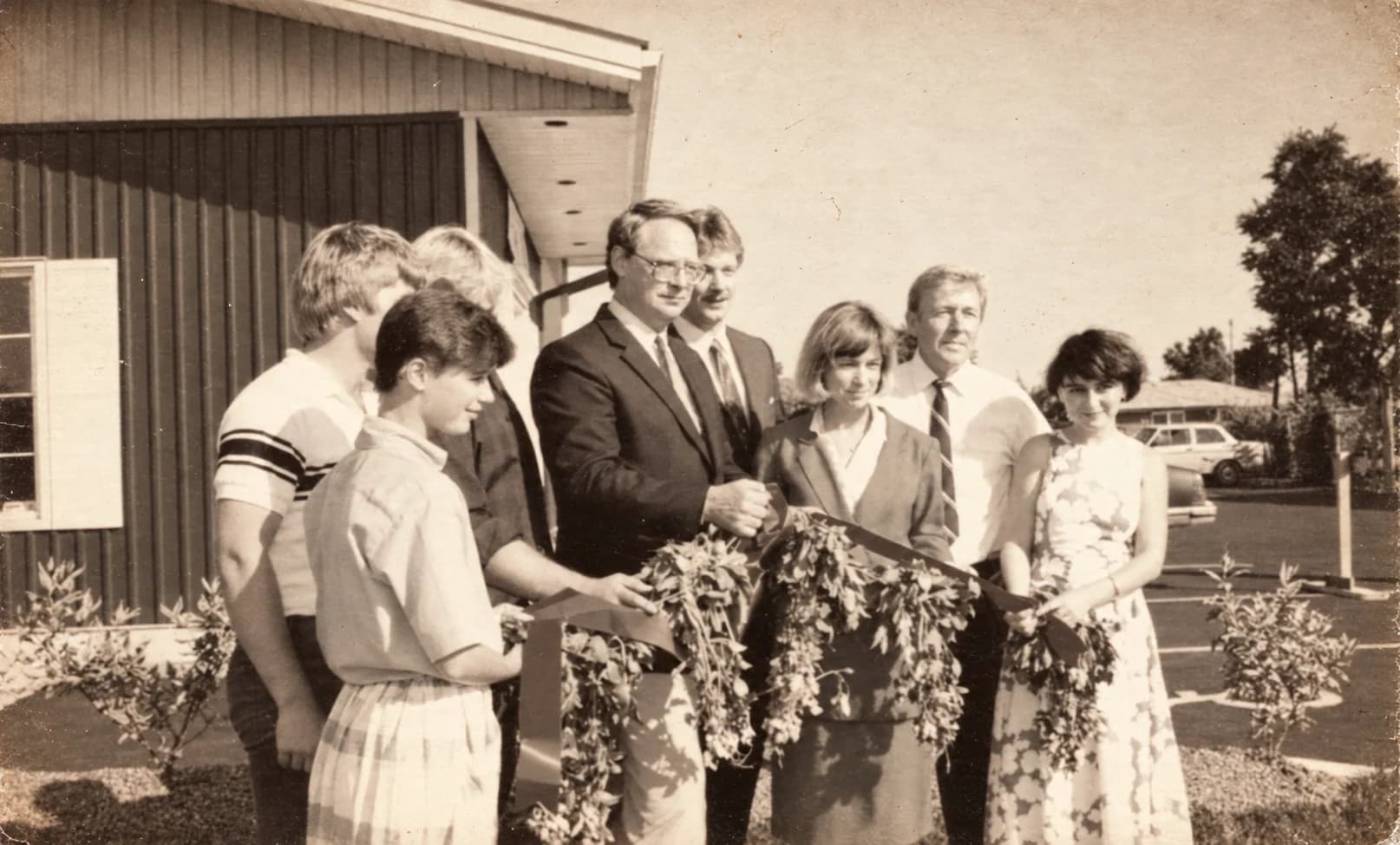 Opening day at a Picard's Blue Barn, July 13, 1986: family and guests cut a ribbon draped with fresh peanut plants